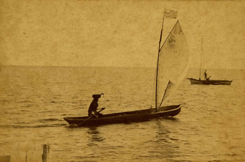 Seminole canoe with sail on Biscayne Bay